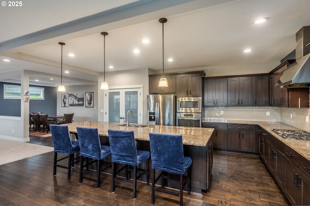 13864 SE Nightingale Ave, Happy Valley, OR 97015 - kitchen with stainless steel appliances, dark brown cabinets, dark wood-style flooring, light stone counters, and recessed lighting