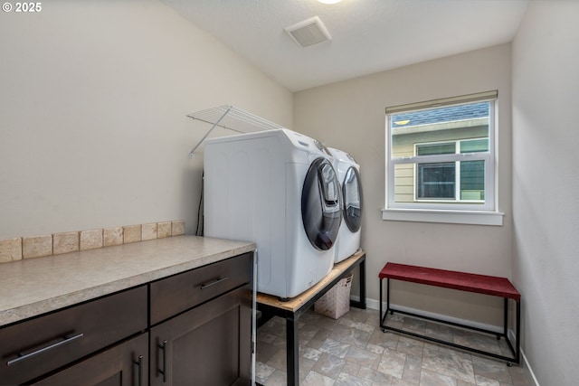 13864 SE Nightingale Ave, Happy Valley, OR 97015 - laundry room featuring washer and dryer, cabinet space, and stone finish flooring
