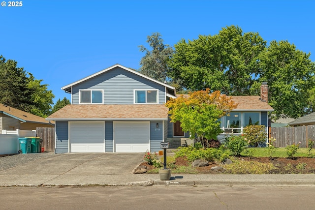 view of front of property featuring concrete driveway, fence, a garage, and a shingled roof