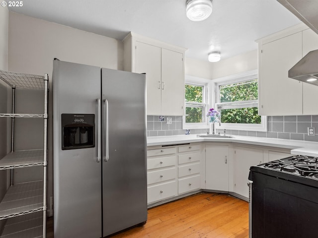 4561 NE 35th Ave, Portland, OR 97211 - kitchen featuring stainless steel refrigerator with ice dispenser, light countertops, and decorative backsplash