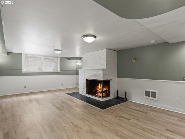 4561 NE 35th Ave, Portland, OR 97211 - unfurnished living room featuring a brick fireplace and wood finished floors