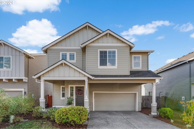 craftsman house with board and batten siding, a shingled roof, driveway, and a garage