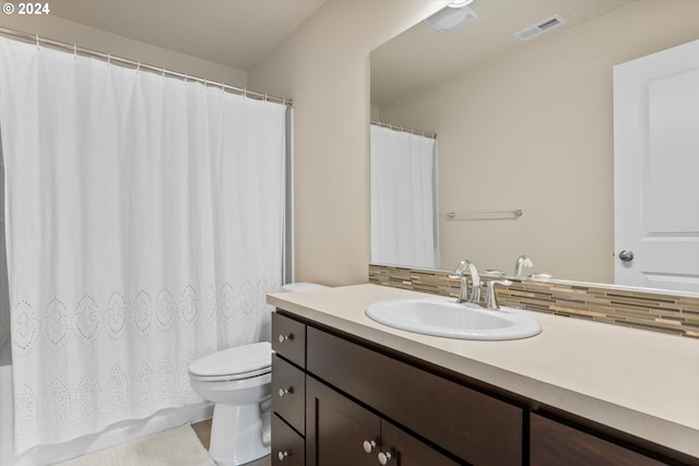 bathroom featuring visible vents, backsplash, toilet, a shower with curtain, and vanity