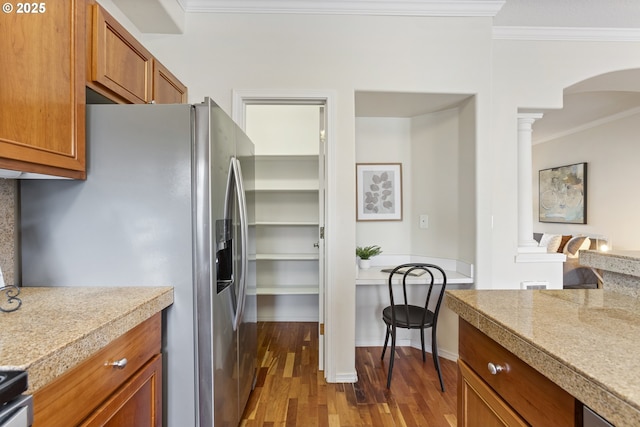 kitchen featuring stainless steel fridge with ice dispenser, tile counters, ornamental molding, brown cabinets, and dark wood-style flooring