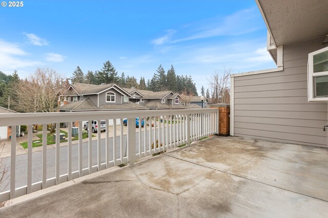 view of patio featuring a residential view and a balcony