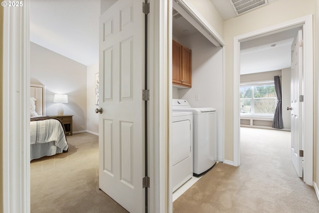 laundry room featuring visible vents, baseboards, light carpet, cabinet space, and independent washer and dryer