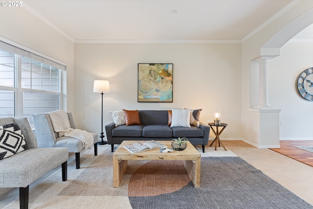 living room with decorative columns, arched walkways, baseboards, and ornamental molding