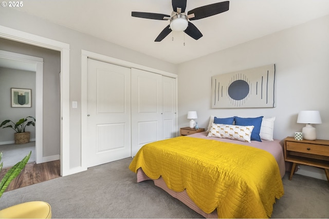 carpeted bedroom with ceiling fan and a closet