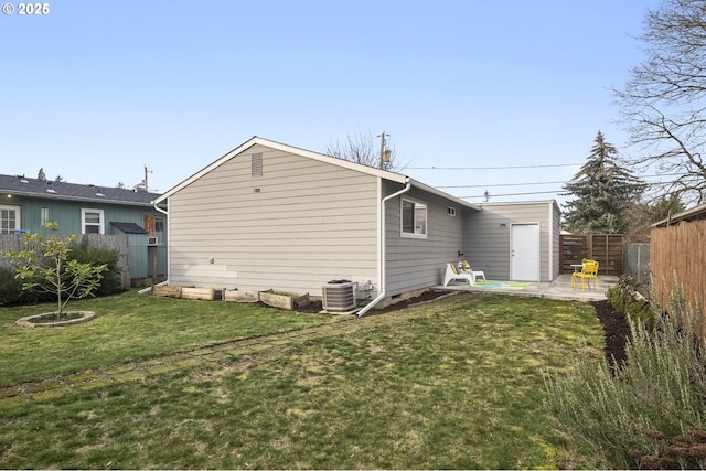 back of house with a yard, central AC unit, and a patio