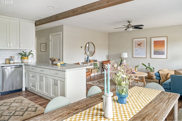 dining space featuring beamed ceiling, ceiling fan, and light hardwood / wood-style flooring