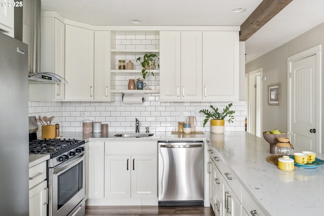 kitchen featuring white cabinetry, sink, decorative backsplash, stainless steel appliances, and light stone countertops