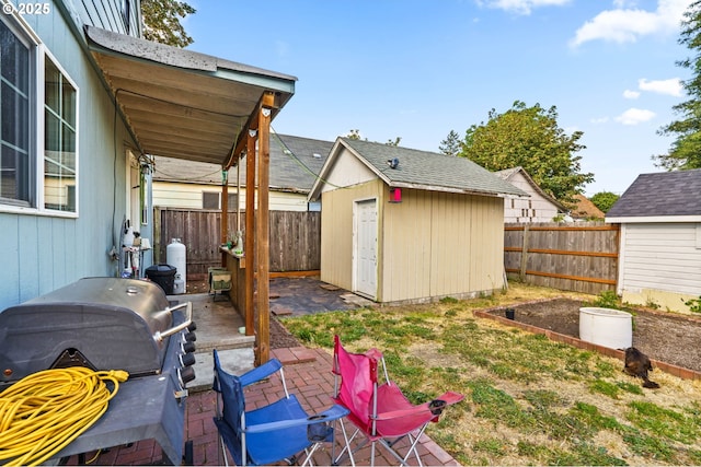 185 N Seneca Rd, Eugene, OR 97402 - fenced backyard featuring a storage unit, a patio, and a garden