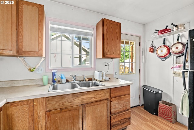 185 N Seneca Rd, Eugene, OR 97402 - kitchen with light countertops, light wood-style flooring, and brown cabinets
