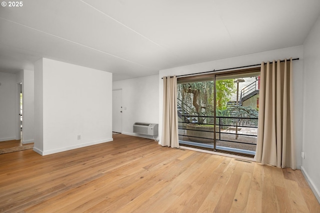 1919 NW Hoyt St Unit 104, Portland, OR 97209 - spare room with light wood-style floors and a wall unit AC