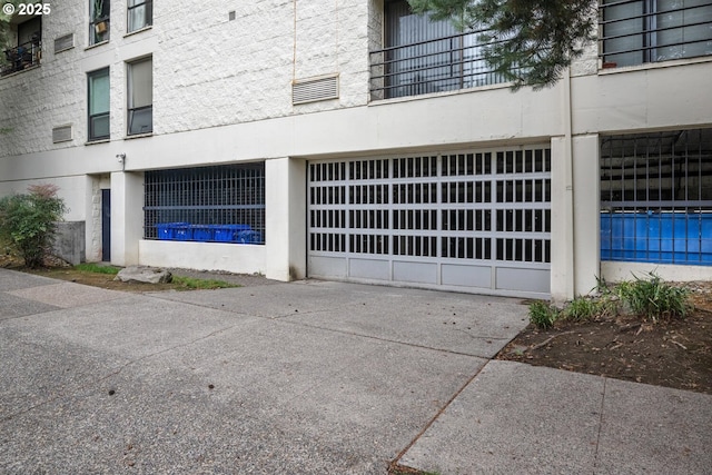1919 NW Hoyt St Unit 104, Portland, OR 97209 - view of building exterior featuring a pool and concrete driveway