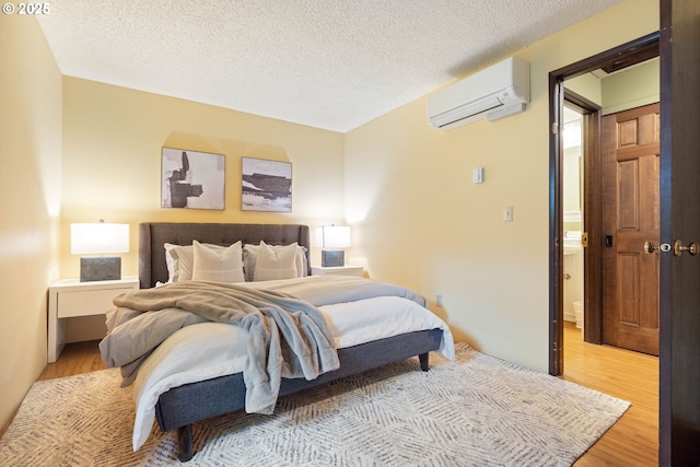 15787 SW Village Cir, Beaverton, OR 97007 - bedroom featuring an AC wall unit, wood finished floors, and a textured ceiling