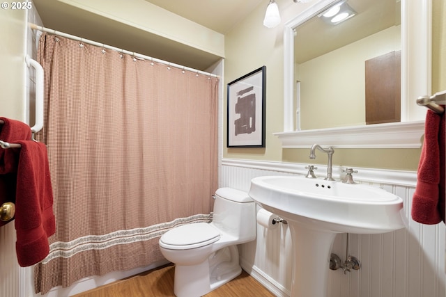 15787 SW Village Cir, Beaverton, OR 97007 - full bathroom featuring toilet, wood finished floors, a wainscoted wall, and a shower with curtain