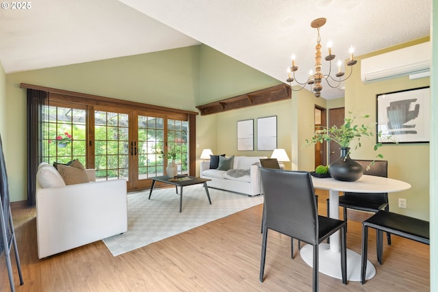 15787 SW Village Cir, Beaverton, OR 97007 - dining room with an AC wall unit, a chandelier, french doors, wood finished floors, and high vaulted ceiling