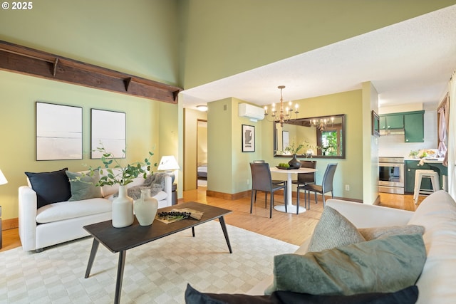 15787 SW Village Cir, Beaverton, OR 97007 - living room with a chandelier, light wood-style floors, a wall mounted AC, and baseboards