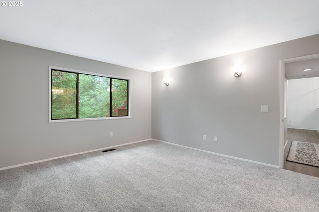 empty room with baseboards and carpet