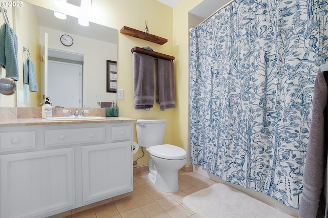 bathroom featuring a shower with curtain, tile patterned flooring, vanity, baseboards, and toilet