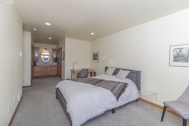 bedroom featuring recessed lighting, light colored carpet, baseboards, and connected bathroom