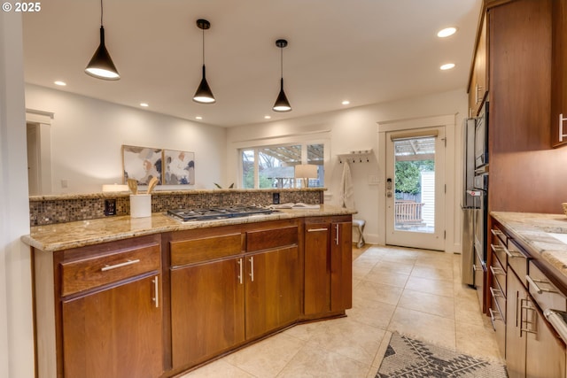 kitchen with recessed lighting, stainless steel appliances, brown cabinets, and decorative light fixtures