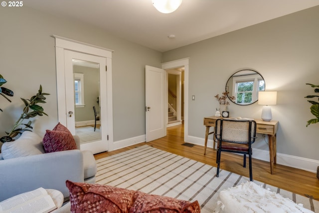 interior space featuring visible vents, light wood-type flooring, and baseboards