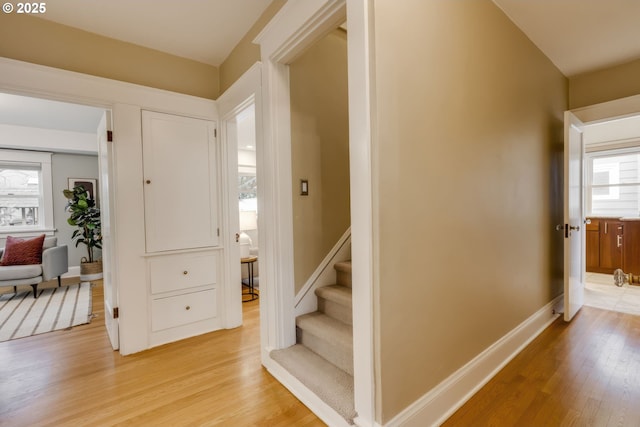 stairway featuring baseboards and wood finished floors