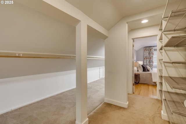 interior space with lofted ceiling and carpet flooring