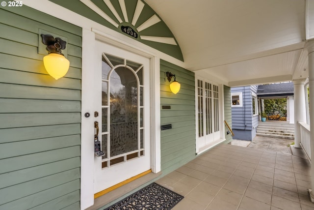 view of exterior entry featuring a porch