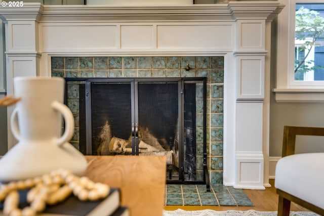 room details featuring wood finished floors and a tile fireplace