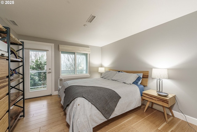 bedroom featuring light wood-type flooring and access to exterior