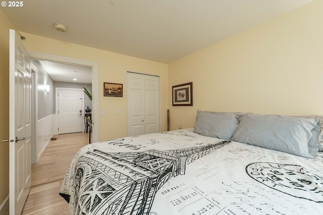 bedroom with a closet and light hardwood / wood-style flooring