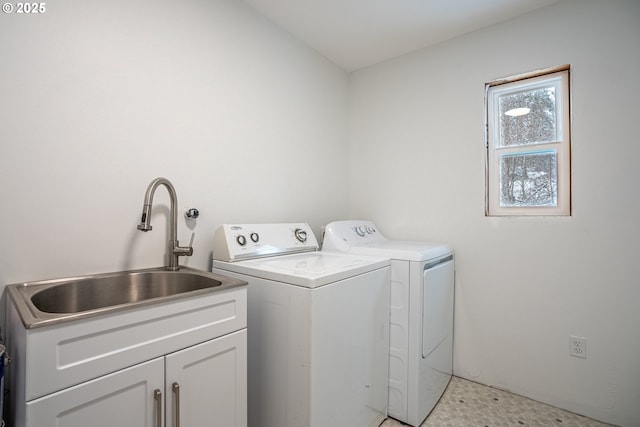 laundry room with sink, cabinets, and separate washer and dryer