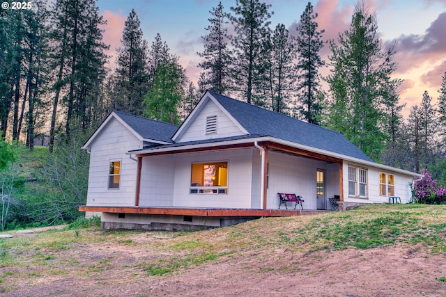 932 Zelinski Rd, Goldendale, WA 98620 - view of front of home with a porch, a shingled roof, and view of wooded area
