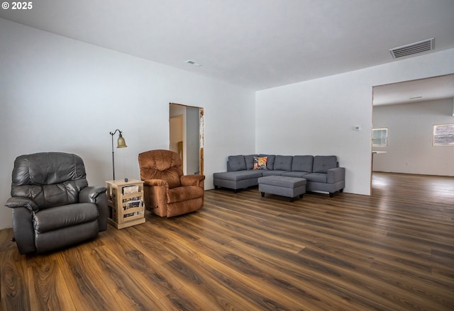 living room featuring dark wood-type flooring