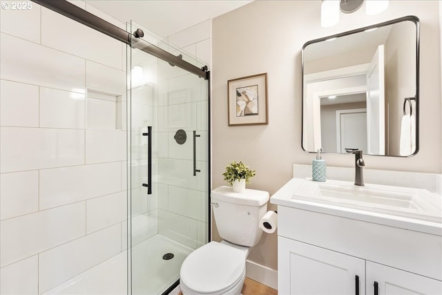 bathroom featuring walk in shower, vanity, and toilet