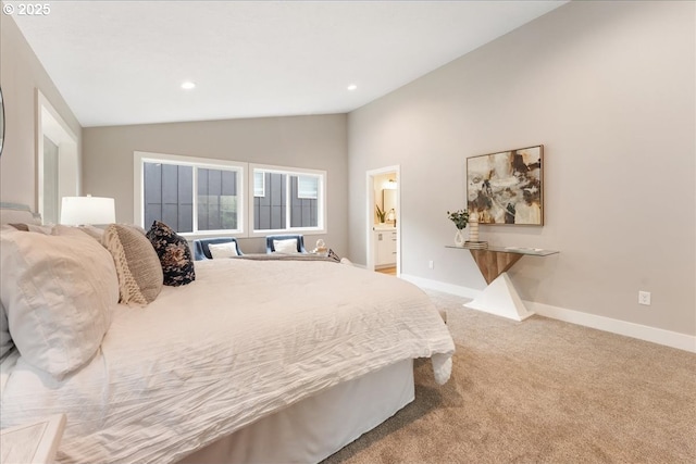 carpeted bedroom featuring ensuite bathroom and vaulted ceiling