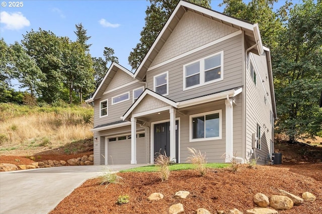 craftsman house with central AC and a garage