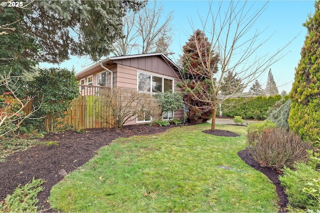 view of side of property with a lawn