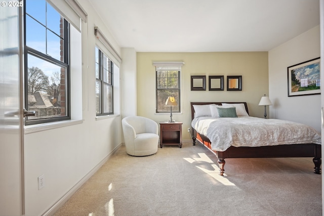 bedroom featuring carpet and baseboards