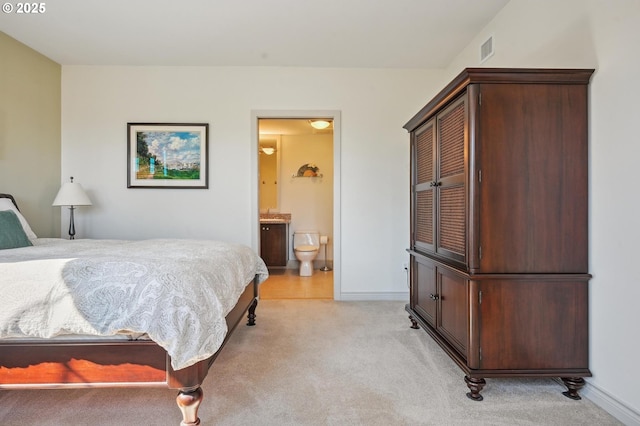 bedroom with baseboards, visible vents, ensuite bathroom, and light colored carpet