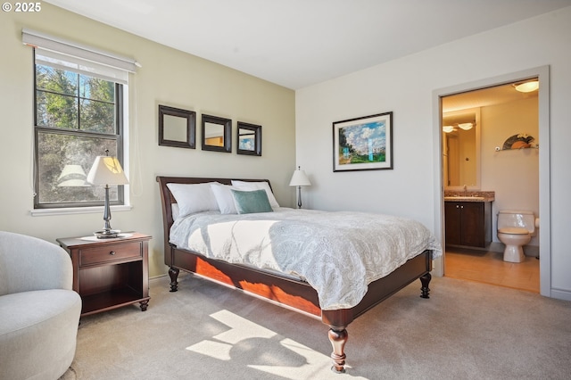 bedroom with a sink, carpet, and ensuite bath