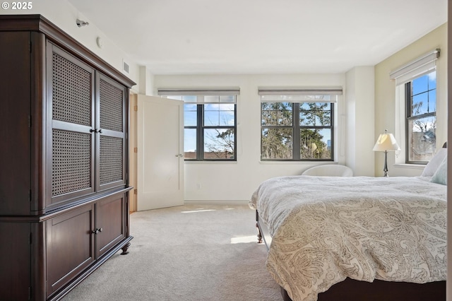 bedroom featuring light carpet and visible vents