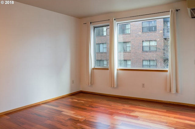 1125 NW 9th Ave, Portland, OR 97209 - empty room with light wood-type flooring and an AC wall unit