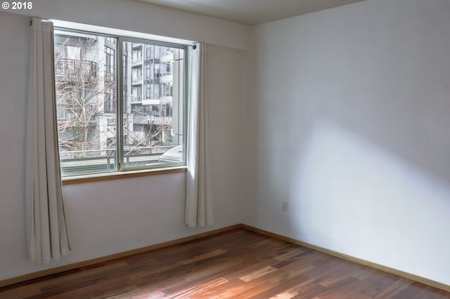 1125 NW 9th Ave, Portland, OR 97209 - empty room with wood finished floors and baseboards
