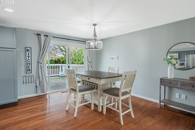 dining area with wood finished floors and baseboards