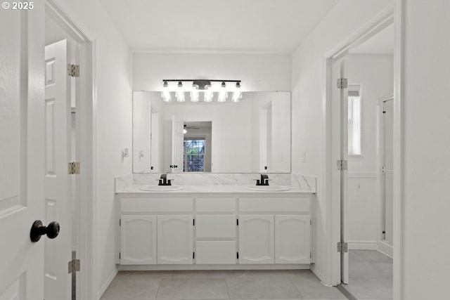 bathroom with double vanity, tile patterned floors, a ceiling fan, and a sink