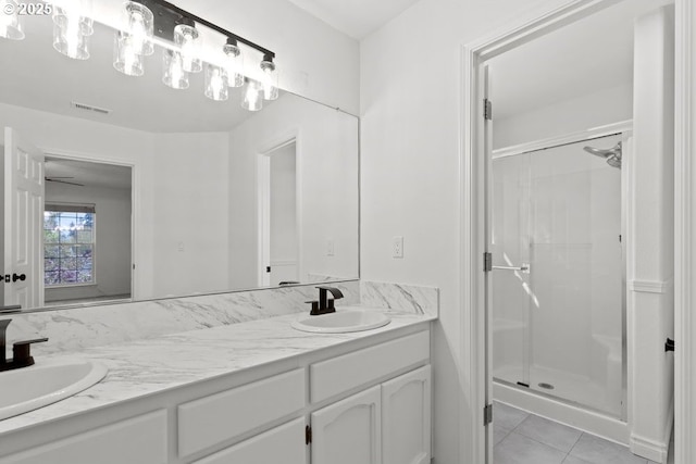 bathroom with double vanity, a sink, and a shower stall